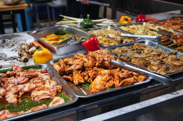 The street market offers a wide range of fresh meat for barbecue