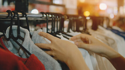 Shopping for clothes in a clothing and fashion department store, clothes racks and hangers