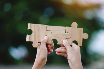 Wooden jigsaw puzzles, put together to convey the meaning of the power of cooperation and unity in teamwork.