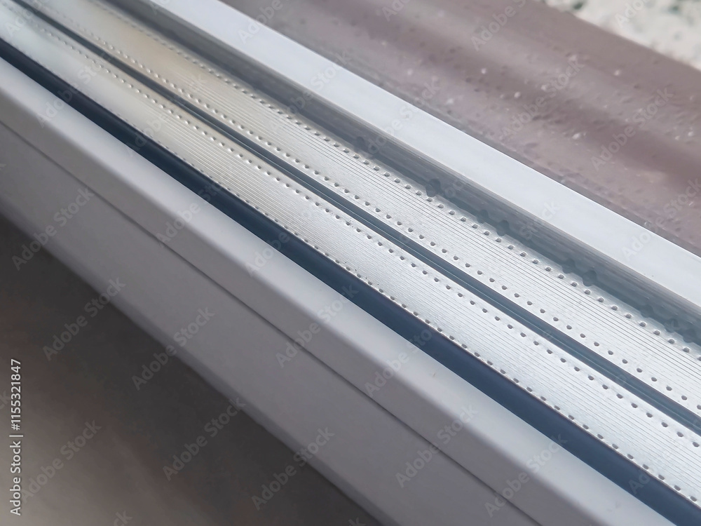 Poster close-up of a window sill with rain droplets. the image captures the texture of the materials and th