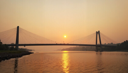 Golden sunset casts a warm glow over the serene river and modern bridge reflecting on the water