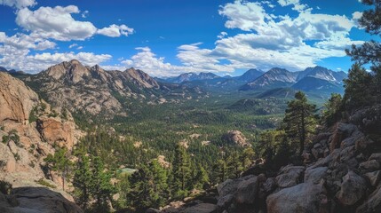Obraz premium Panoramic view of Sierra mountain range showcasing lush greenery and dramatic clouds under a bright blue sky
