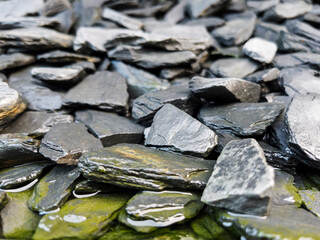Textured Black Slate Stones with Water Reflection