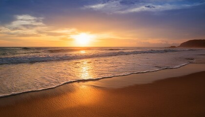 golden sundown over calm ocean waves on sandy beach