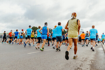 rear view large group runners run started marathon race