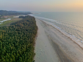 Aerial View of Coastal Forests and Expansive Sandy Shoreline at Sunset in Cox's Bazar District, Bangladesh