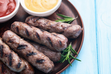 Grilled beef sausages with rosemary sauce and tomatoes photography . Top view