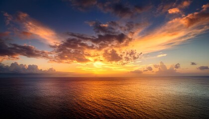 Naklejka premium sunset sky clouds over sea in the night with orange yellow gold daylight in golden hour and dramatic fluffy horizon sea sky landscape dusk sky history