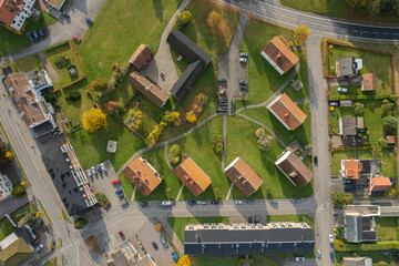 A series of low and cozy residential buildings in Europe. Old housing stock with well-organized courtyard infrastructure. Aerial view, drone shot.
