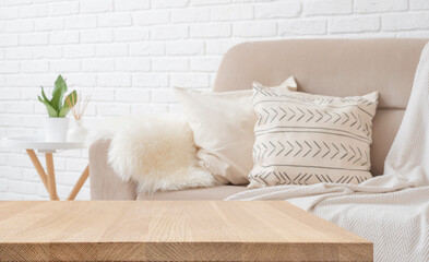 Wooden table top for product display montage on blurred living room interior background