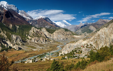 Picturesque view of Marsyangdi River valley and Bhraka village, flowing along northern slopes of Annapurna mountain range. Himalayas, Nepal.