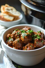 Delicious Sweet and Chili Meatballs Cooked in a Crockpot Served in a Bowl with Fresh Herbs and Bread on the Side