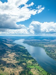 Stunning Aerial Shot of Serene River Winding Through Expansive Mountain Valley Reflecting Fluffy Clouds in Blue Sky : Generative AI