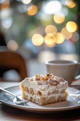 Soft and Delicious Tres Leches Cake Served on a White Plate with a Blurred Cafe Background and Beautiful Bokeh Effect in the Atmosphere