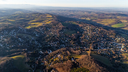Fototapeta premium Aerial View of Austrian Villages and Wild Forests: Drone Footage of Austria's Untouched Nature, showcasing the breathtaking beauty of remote landscapes.