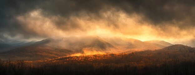 Fototapeta premium Panoramic view of the mountains in the clouds, during the golden hour
