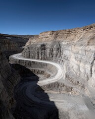 Vast Earth Excavation Surrounded by High Rocky Walls and Clear Sky
