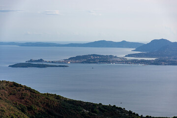 Tranquil islands and coastline seen from a mountaintop vista.