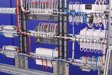 The reverse side of the electrical switchboard. The connected wires are tied with plastic ties.