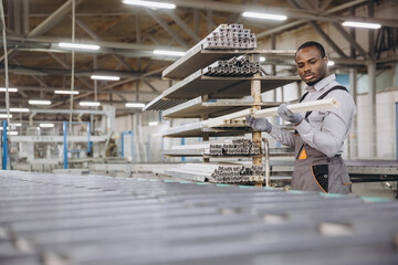 Factory worker checking pvc window and door frames in aluminum and pvc windows and doors production