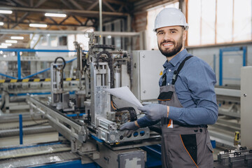 Factory worker inspecting aluminum and pvc windows and doors production line