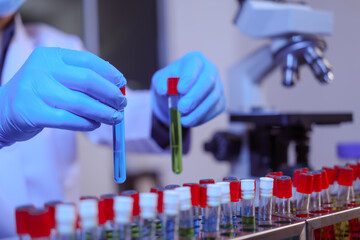 Close-up of a male scientist analyzing blood vessels in a modern laboratory. He is experimenting...