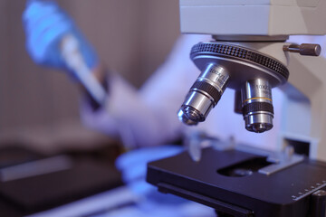 Close-up of a male scientist analyzing blood vessels in a modern laboratory. He is experimenting with chemicals in liquids, showing the scientific innovations in cutting-edge biomedical research