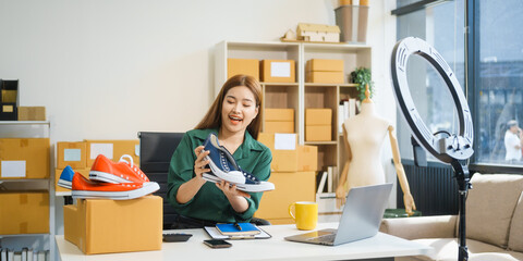 A beautiful Asian woman shares her journey of selling shoes via live camera on social media from...