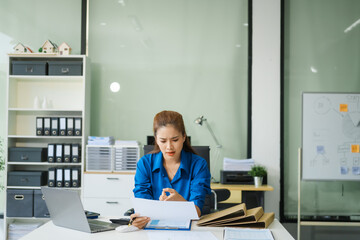 A businesswoman working at a desk in an office struggles with stress and headaches caused by Office Syndrome, a condition linked to prolonged sitting excessive computer use during long working hours