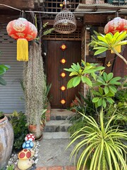 A variety of plants are flourishing in front of a large building