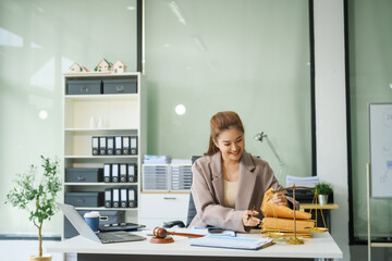A young female lawyer sits at her desk in the office, providing online legal advice professionally....