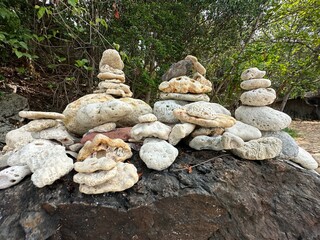 A pile of rocks that are neatly stacked on top of each other on a rock surface