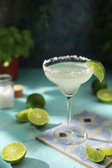 A glass with margarita cocktail with lime	