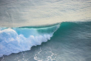 Blue and turquoise clean ocean crashing wave. Natural tropical oceanic water beauty.