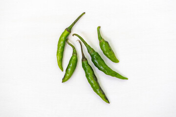 Fresh green chili peppers isolated on a white background. Top view.