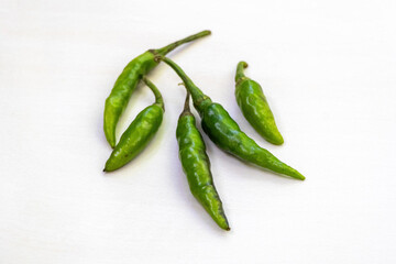 Fresh green chili peppers isolated on a white background.
