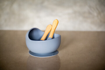 Grey silicone baby tableware, consisting of a bowl, fork and spoon