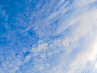 Clouds floating in blue sky.