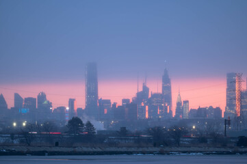 Fototapeta premium Stunning manhatta NYC skyline during sunrise winter season, far away skyline taken from New Jersy side, copy space travel world famous destination