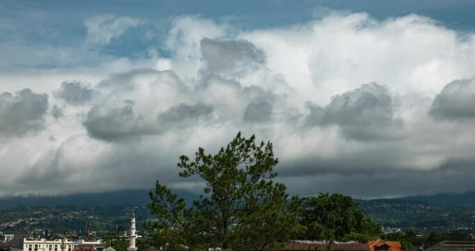 Timelapse of thick clouds rolling over the suburban area in Bandung, Indonesia