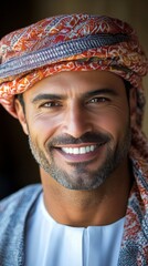 Smiling man wearing traditional attire in a warm, cultural setting of the Middle East