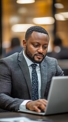 Obraz premium Professional man working on laptop in modern office setting during daytime