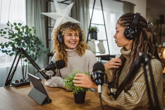 Two young women stream audio podcast about home plant at home studio