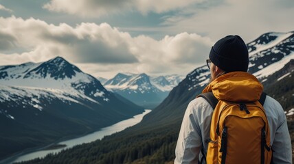 Backpacker in majestic northern mountains with rugged terrain and a heavy backpack