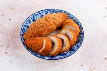 Chicken Kiev cutlets on a plate with fresh green.