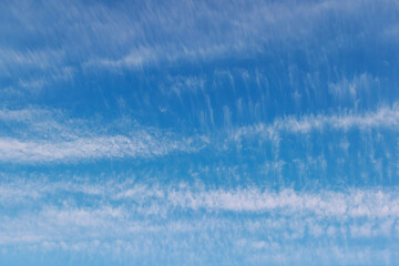 Blue Sky, Gentle Cloud Wisps, Soft Color Gradient, Peaceful Daytime Scenery Backdrop, Subtle Cloud Formations, Open Air Space, Atmospheric Calmness, Light Fluffy Clouds, Delicate Skyline