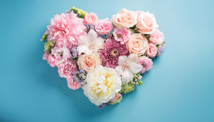 Vibrant heart shaped floral composition on blue background. Beautiful flowers. Love, romantic