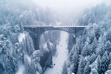 snow-covered landwasser viaduct, birds-eye view of snow-covered landwasser viaduct towering over pine forests, as a drone captures a high-speed train crossing its icy path gracefully