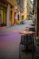 Outdoor Tables with Glassware in a Vibrant Alley on the French Riviera