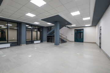 panorama view in empty modern hall with columns, doors and panoramic windows at night